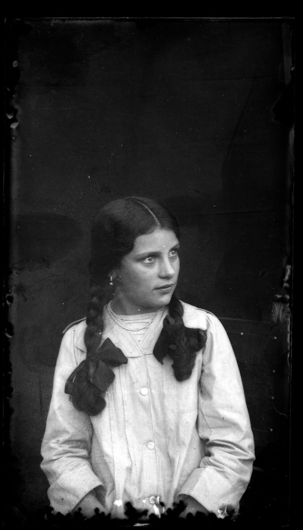 NIÑA CON TRENZAS Y EXPRESIVOS OJOS.